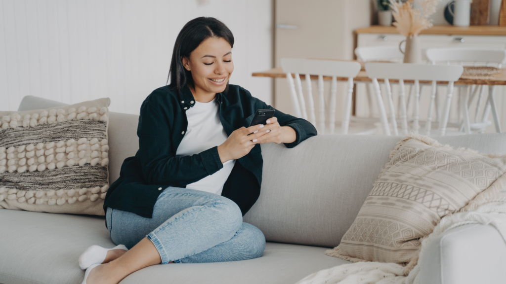 Blog-Featured-Image-2 Woman sitting on couch and looking at phone